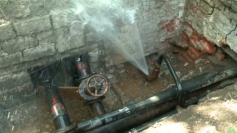 Water flows from a rusty water pipe. Water accident Stock Footage 136655432