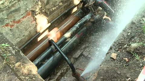 Water flows from a rusty water pipe. Water accident Stock Footage 136656239