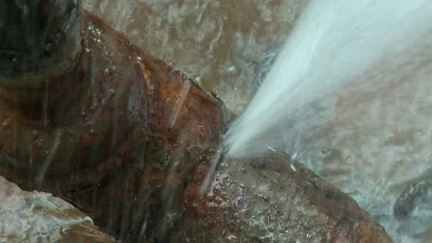 Water flows from a rusty water pipe. Water accident Stock Footage 136656682