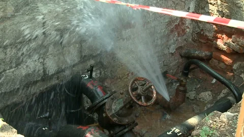 Water flows from a rusty water pipe. Water accident Stock Footage 136657273