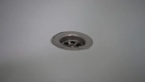 Water flows into the sewer through a hole in the bathroom Stock Footage 223661297