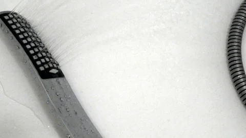 Water flows from the shower head on a white background Stock Footage 87587388