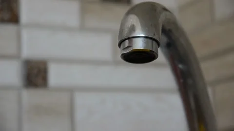 Water flows from a сhrome tap in the kitchen close-up Stock Footage 127060947