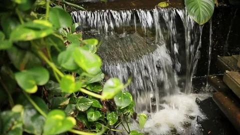 The water flows as a small decorative waterfall. Wat Saket (Golden Mount Stock Footage