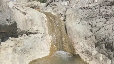 Water flows in small mountain waterfall 動画素材 316783380