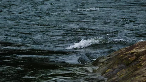 Water flows smoothly over wet rocks Stock Footage 335809752