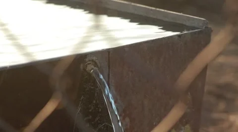 Water Flows From a Tank to Ground Through Grid View From Top Down Stock Footage 62472636