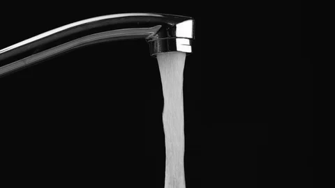 Water flows from the tap on a black background, then the water stops Stock-Footage 111531263