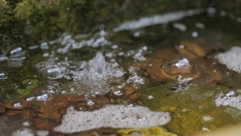 Water flows from a tap in the courtyard in the old oriental style Stock Footage 124703987