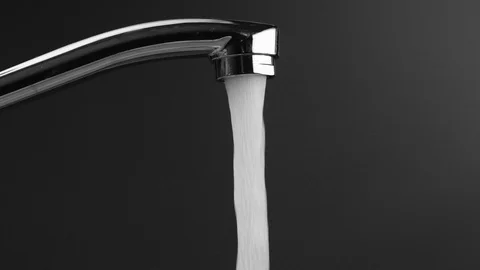 Water flows from the tap on a grey background, then the water stops Stock Footage 111531627