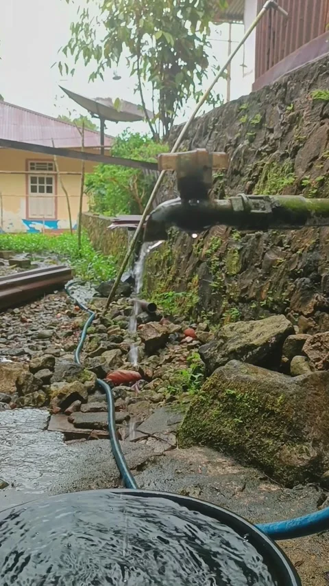 Water flows from the tap on the side of the house non-stop Stock Footage 240631937