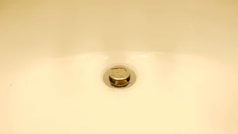 Water Flows from a Tap into a Sink. Close-up view. Stock Footage 101928775