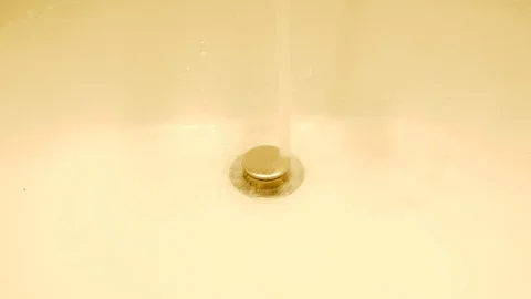 Water Flows from a Tap into a Sink. Close-up view. Stock-Footage 102438852