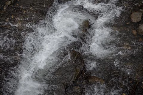 Water flows through the bones. Mountain river. Stock Photos