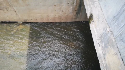 Water flows through concrete drainage ditches. Selective focus Stock Footage 125650185