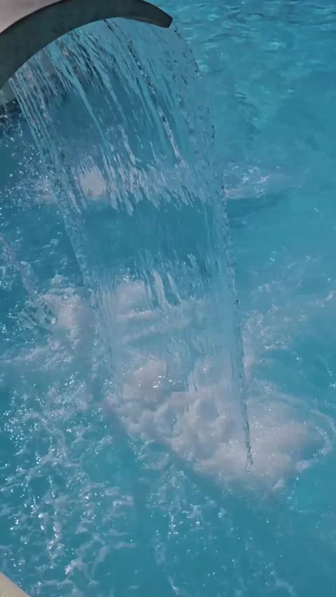 Water Flows Through The Flat Pipe Into Pool. Vertical video Stock Footage 248967113
