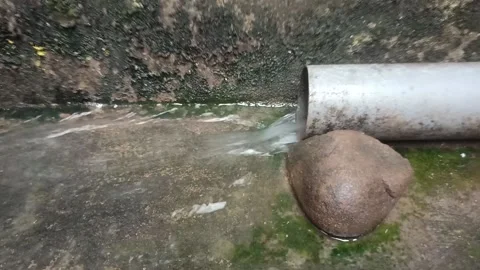 Water flows through the pipe behind the house Stock Footage 211789184