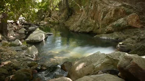 Water flows through a quiet pool Stock Footage 11235600