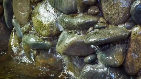 Water flows through a stone wall in a cave. Stock Footage 119070575