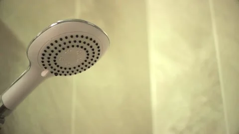 Water flows through the white shower head in bathroom Stock Footage 131375551