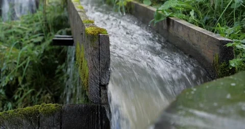 Water flows through wooden gutter. Valilo - natural eco-friendly washing machine Video stock 143425150