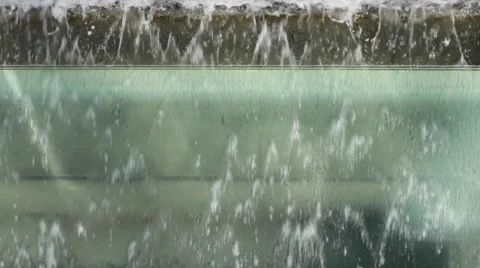 Water flows upside down from a curved glass fountain fountai Video stock 49413678