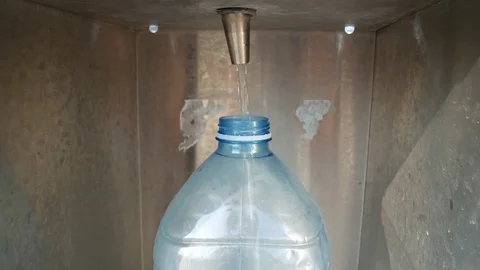 Water flows from the vending machine into a plastic bottle. Video stock 78530230