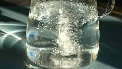 Water flows visually, Bright sunlight illuminates water cascading into Stock Footage 337547250
