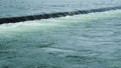 Water flows from the weir of a large dam. Stock Footage 147965989