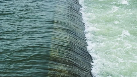 Water flows from the weir of a large dam. Stock Footage 147966274