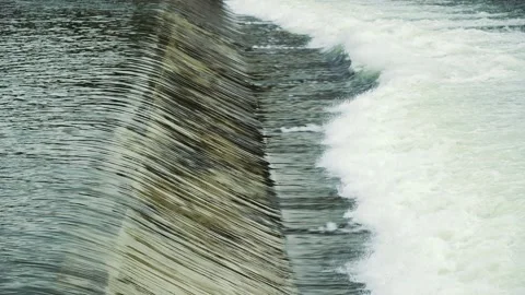 Water flows from the weir of a large dam. Stock Footage 147966345