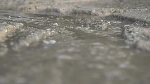 Water flows on a white sand beach Stock Footage 132396884