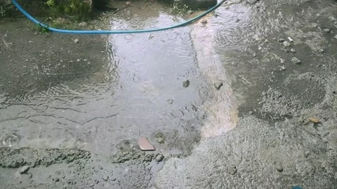 Water flows in the yard due to quite heavy rain Video stock 303887066