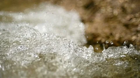 Water flushes into a pool and creates abstract figures and bubbles (slow motion) Stock-Footage 219641768