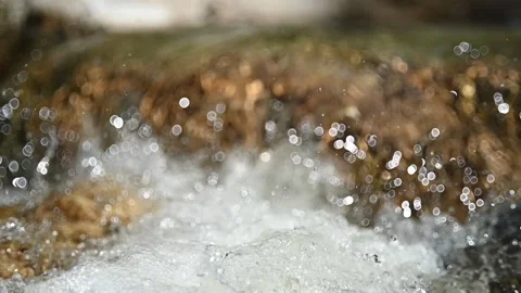Water flushing over rocks in a mountain stream (slow motion, bokeh) 스톡 동영상 219391348