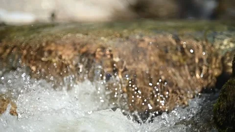 Water flushing over rocks in a mountain stream (slow motion, bokeh) Stock-Footage 219418647