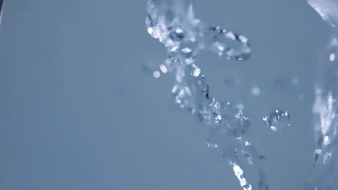 Water fly against to the camera on a blue background in slow motion Video stock 302351038