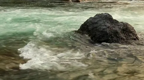 Water forming small rapids  in river Stock Footage 65771106