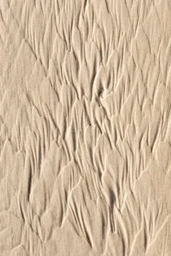 Water forms spectacular patterns at the sandy beach 스톡 사진