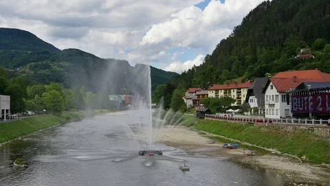Water fountaine on river Savinja in front of city Laško in Slovenia Stock Footage