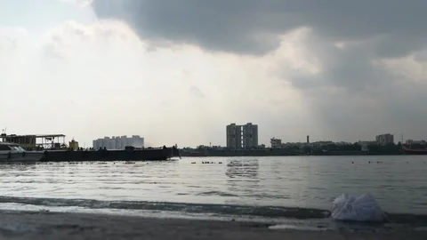 The water of the Ganges River is being polluted due to the dumping of waste. Stock Footage 340776606