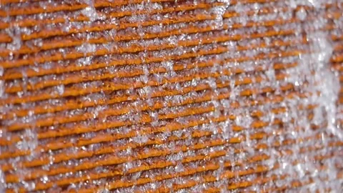 Water gently cascading down a rough surface creating a textured and soothin.. Stock Footage 286199056