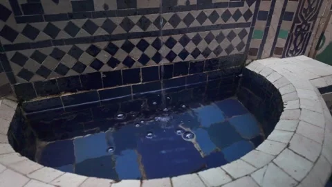 Water Gently Flows into a Beautiful Tiled Fountain with Ornate Patterns Stock Footage 341903632