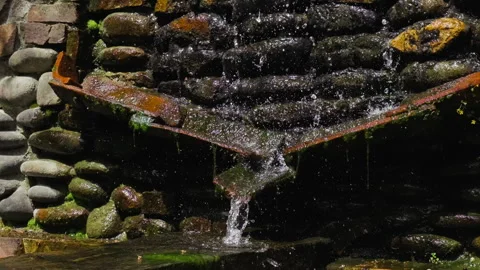 Water gently flows down a stone wall. Water source Stock Footage 280222477