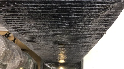 Water gently rolling down wall Stock-Footage 104736824