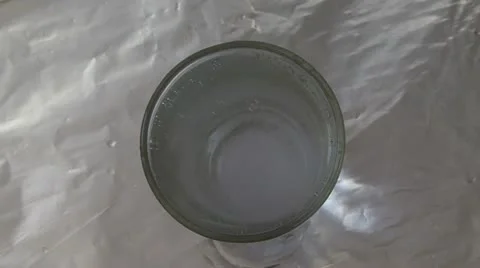  water in a glass is bubbled from a dissolving tablet. view from above Stock Footage 10825688