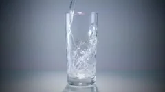 Pouring water into a glass - Stock Image - F006/7235 - Science