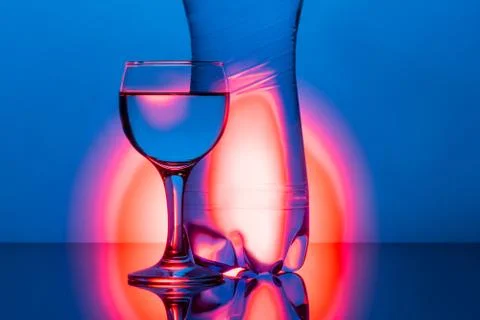Water glass with reflection on  background Stock Photos