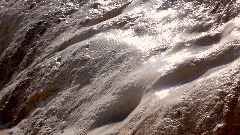 Water glitters in  sun and flows through calcareous deposits on  mountain 스톡 동영상 81011547