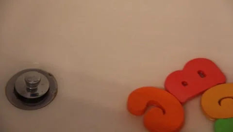 Water Going Down The Drain With Toy Letters #2 Stock Footage 7195622